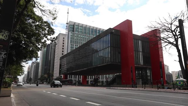 Sao Paulo Museum of Art in a wide angle exterior shot as traffic passes by in the foreground