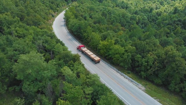 Aerial of Semi Truck Driving with Lumber