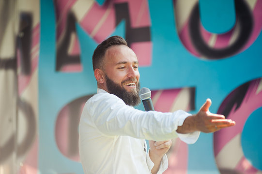 Presenter On Stage With Microphone