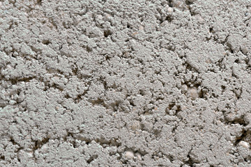 Gray wall background of sand with seashells and cement