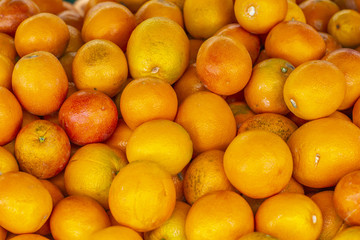 Fresh ripe overflowing box of oranges ready for eating