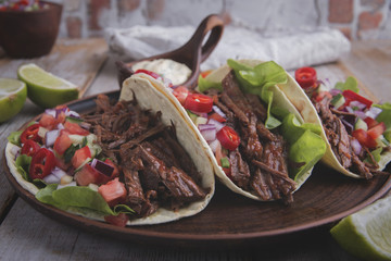 Mexican tacos with roasted beef ,sauce and salsa tomato