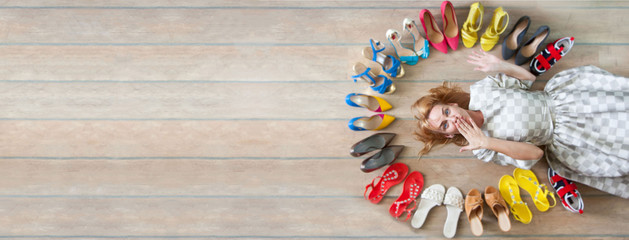 Woman choosing shoes. Colored shoes are exposed in a circle. - obrazy, fototapety, plakaty