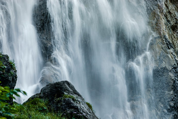 Fototapeta na wymiar Beautiful high waterfall in swiss Alps, summer