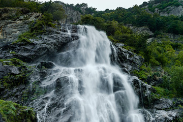 Beautiful high waterfall in swiss Alps, summer