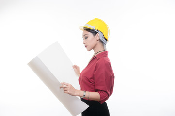 Beautiful engineering woman reading blueprint with yellow helmet and red shirt with white background, Studio light portrait