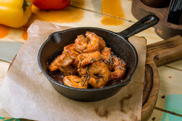 Tiger prawns fried in a cast iron pan