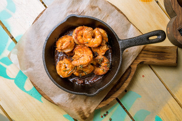 Tiger prawns fried in a cast iron pan