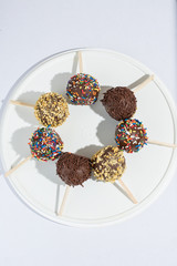 chocolate lollipop with colorful sparks with peanuts and chocolate sparks