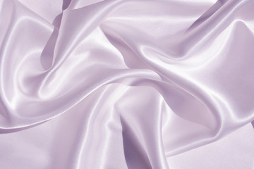The texture of the satin fabric of lilac color for the background 