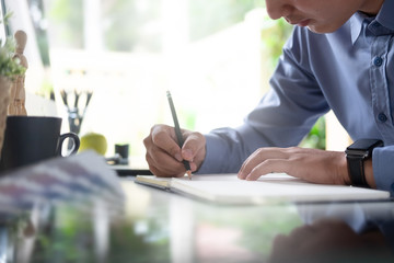 Businessman working writing on paper note.