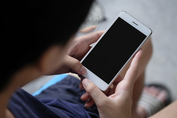 Cropped shot view of man hands holding smart phone with blank copy space screen for your text message or information content a rent time man sitting and using smartphone.