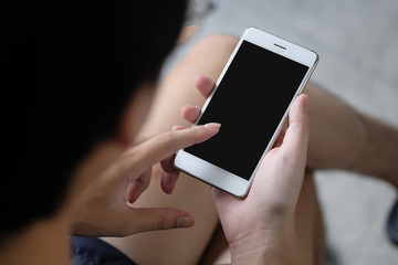 Cropped shot view of man hands holding smart phone with blank copy space screen for your text message or information content a rent time man sitting and using smartphone.