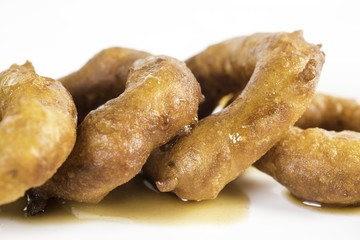 Picarones: These are ring-shaped dessert made with wheat flour dough mixed with pumpkin and sweet potato. fried and dipped in fig molasses.