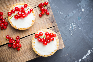 Red currant cake decorated with fresh ripe berries on the rustic background. Selective focus. Shallow depth of field.