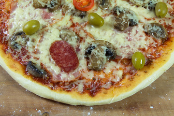 Hot appetite baked pizza. Variety of attachments on the wooden table