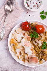 Slices of fried fish with vegetables