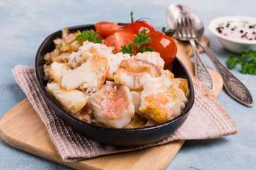 Slices of fried fish with vegetables