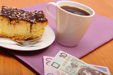 Paying for cheesecake and coffee in cafe using polisg currency money