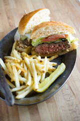 French fries and burger on metal plate