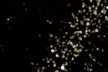 bokeh of water drops levitating in the air reflection