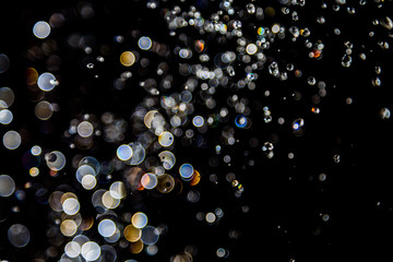 bokeh of water drops levitating in the air reflection