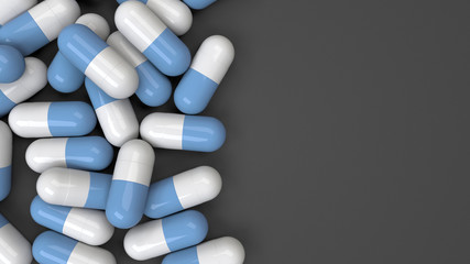 Pile of white and blue medicine capsules