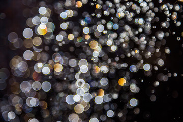 bokeh of water drops levitating in the air reflection