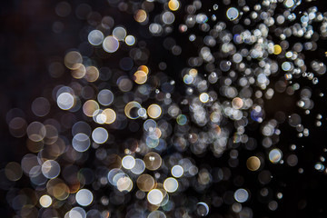 bokeh of water drops levitating in the air reflection