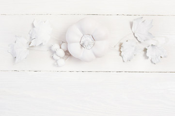 white mockup pumpkin, berries and leaves on a wooden autumn background. Greeting card for Thanksgiving Day in rustic style with space for your text. Flat lay. Top view