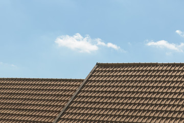 Beige tile roofs texture at noon with sky and cloud