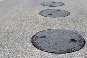 Metal drain cap cover on the walk way