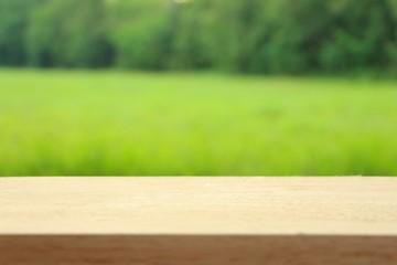 Wood table top on blur abstract green from park in the morning background,For montage product display or design layout