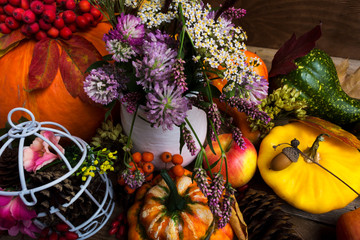 Thanksgiving decor with yellow, green, orange squash and clower