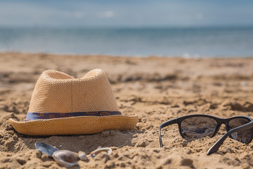Fototapeta na wymiar Sunglasses on sandy beach in a summer.