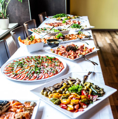 Party Brunch big Buffet table setting with Food Meat Vegetables