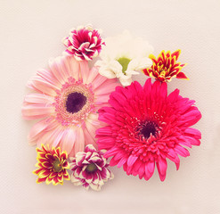 Top view of flowers arrangement over white background. Copy space.