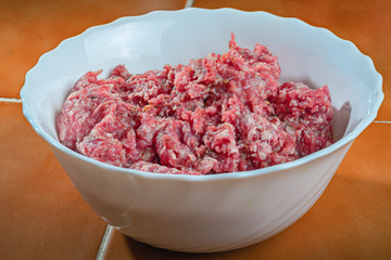 Meat: Raw Minced Meat in white deep plate.