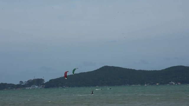 Thai people playing kiteboarding or sea kite in the sea  at Ban Pae beach on July 3, 2018 in Rayong, Thailand