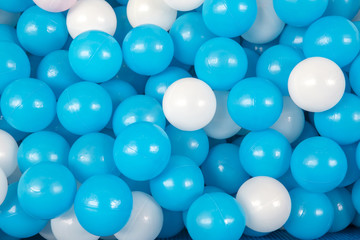 Colorful colored plastic balls on playground in kid playroom