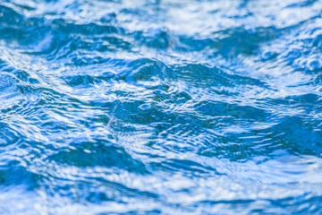 The bright blue waves on a water