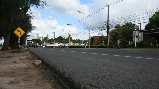 Thai people riding and driving on the road at Ban Phe village city on July 4, 2018 in Rayong, Thailand