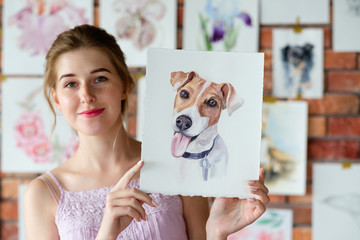 Naklejka premium creative art lifestyle. drawing hobby and self expression. painter holding a watercolor drawing of french bulldog dog