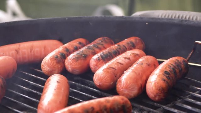 Juicy sausages and grilled vegetables on grill. Dinner outdoors. Garden party