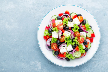 Greek salad of fresh cucumber, tomato, sweet pepper, lettuce, red onion, feta cheese and olives...