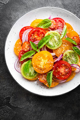 Tomato salad. Fresh vegetable salad with tomatoes, onion and basil