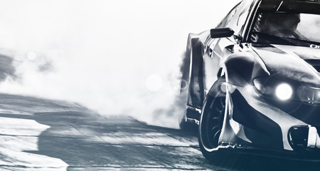 Blurred sport car drifting on speed track. Sport car wheel drifting and smoking with flare effect on track. Sport concept,drifting car concept. - obrazy, fototapety, plakaty