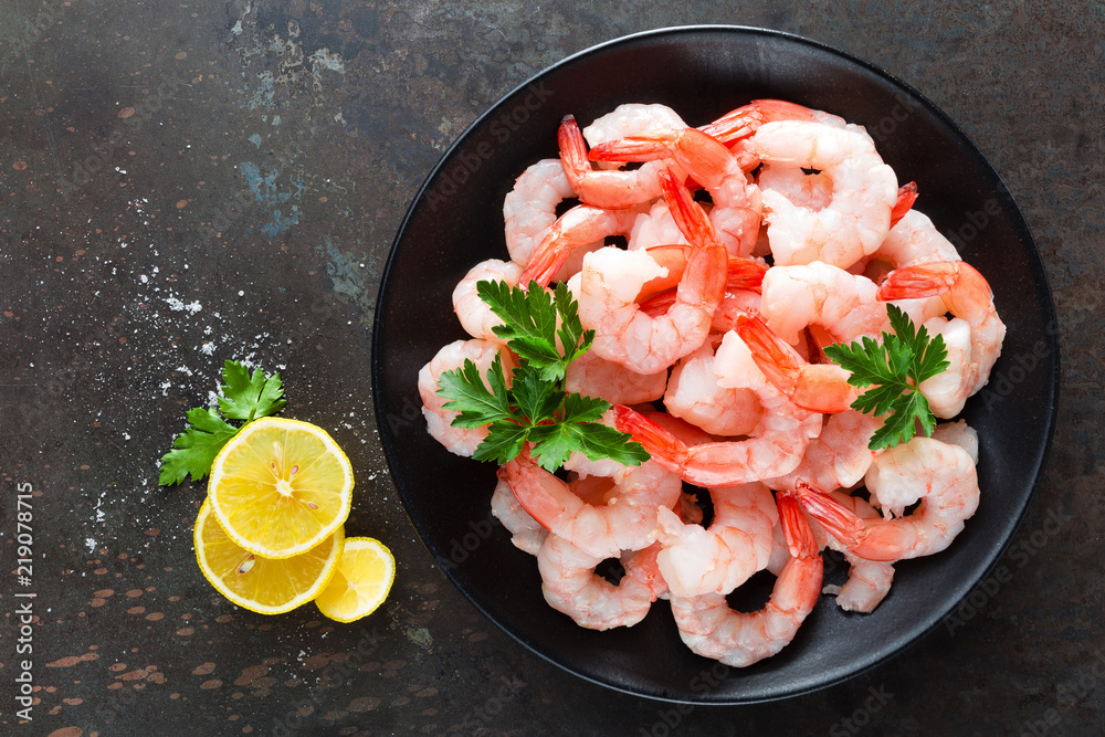 Wall mural prawns on plate. shrimps, prawns. seafood. top view. dark background