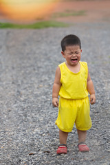 boy in yellow dress is crying