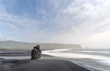 The dramatic view of the Reynisdrangar Sea Stacks and the black sand beach of Vik, Iceland from Dyrhólaey.